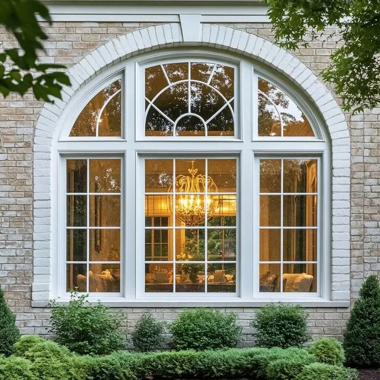 Arched residential window with multi-pane glass and white frames
